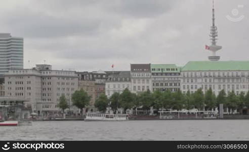 Hamgurg, Germany. River boats with deutschland flag at Elbe river.