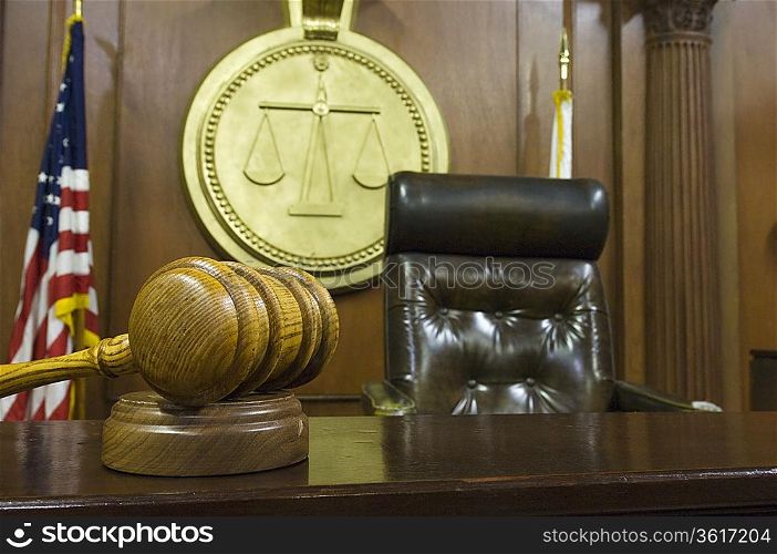 Hammer and gavel near judges chair in court