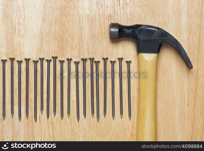 Hammer and Nails Abstract on Wood Background.