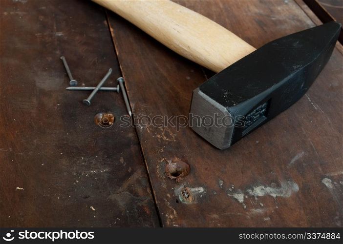 Hammer and Nails on Old Wooden Planks