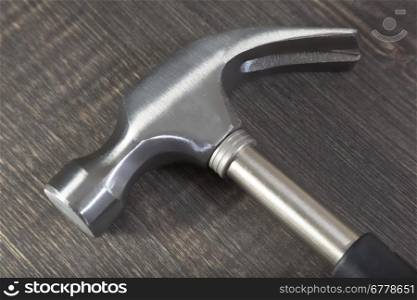 Hammer on the wooden background