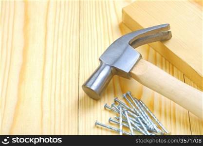 hammer with nails and plank