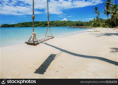 Hammock on tree at sea with the blue sky.