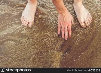 Hand and feet in sea water