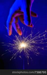 Hand and Fire Light Sparkler in night