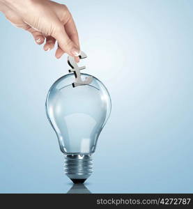 Hand and money inside an electric light bulb