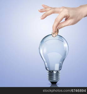 Hand and money inside an electric light bulb