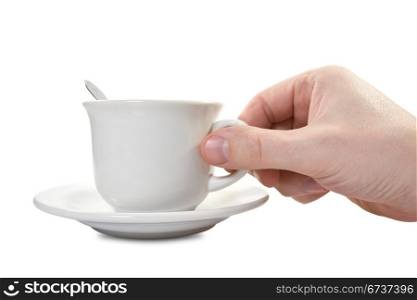 hand and teacup with plate over a white background