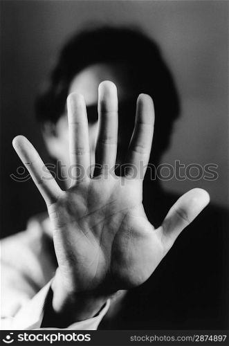 Hand Blocking Man&acute;s Face