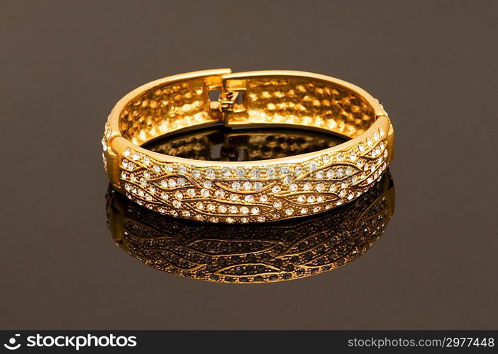 Hand bracelet on the highly reflective background