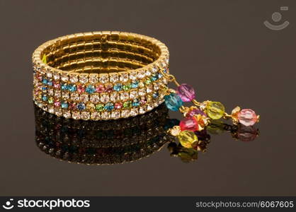 Hand bracelet on the highly reflective background