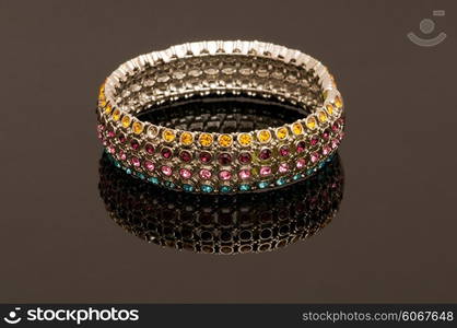 Hand bracelet on the highly reflective background