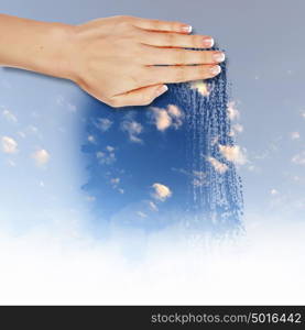 Hand cleaning window with blue sky and white clouds