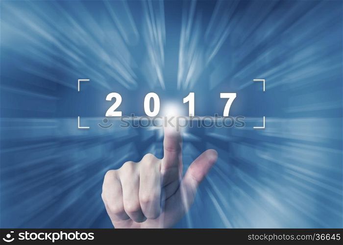 hand clicking on 2017 button with zoom effect background