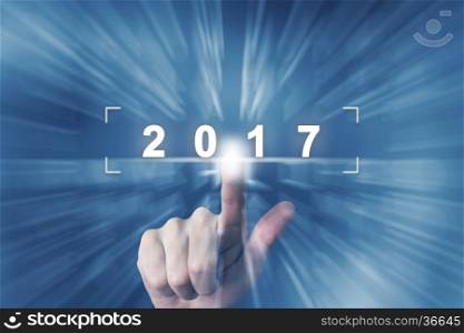 hand clicking on 2017 button with zoom effect background