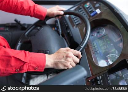 Hand close up of couch driver driving passenger bus