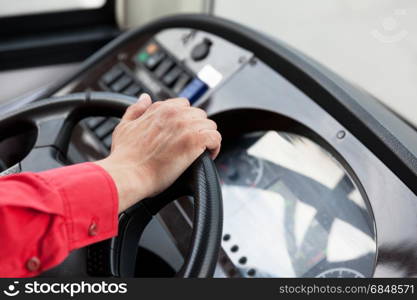 Hand close up of couch driver driving passenger bus