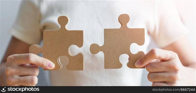 Hand connecting couple puzzle piece. Business Solving, mission, challenge, success, goals, target and strategy concepts