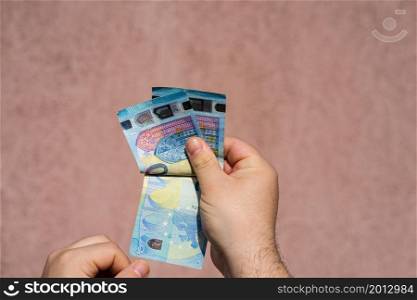Hand couting holding and showing euro money or giving money. World money concept, 20 EURO banknotes EUR currency isolated with copy space. Concept of rich business people, saving or spending money.