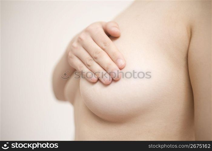 hand covering breasts