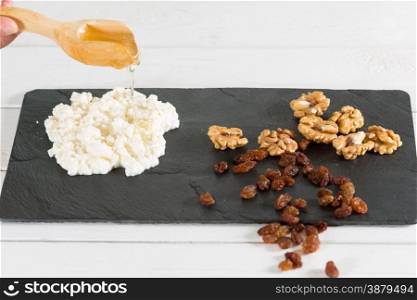 Hand crafted cheese with nuts and homemade honey