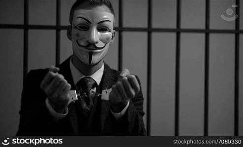 Hand cuffed Anonymous hacker in jail (B/W Version)