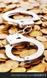 Hand cuffs and coins as security concept