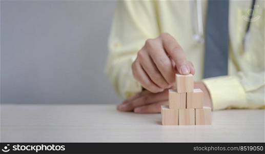 Hand doctor holding wood cube block.Business growth success concept panorama background.