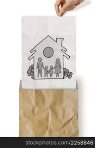 hand draw family and house on crumpled paper as insurance concept