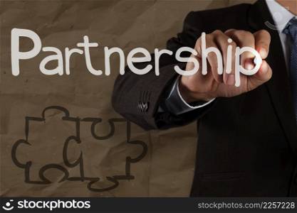 Hand drawing Partnership Puzzle with crumpled recycle paper background as concept