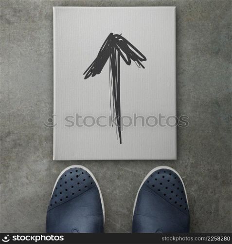 Hand drawn arrow design doodle icon on front of business man feet as concept 