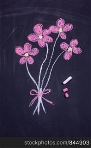 hand drawn flower on a black board