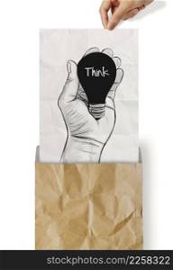 Hand drawn light bulb with THINK word on crumpled paper as concept
