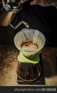 Hand drip coffee , Barista pouring water on coffee ground with filter.  