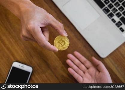 hand exchange golden metal Bitcoin crypto currency investment- symbolic block chain financial internet and technology. hand exchange golden metal Bitcoin crypto currency investment- s