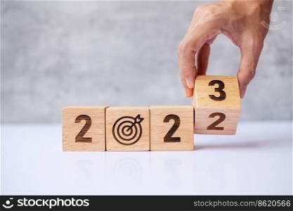 hand flip 2022 to 2023 block with dartboard sign. Business Goal, Target, Resolution, strategy, plan, Action motivation, change, thinking, countdown and New Year start concepts