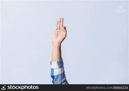 Hand gesturing the letter F in sign language on isolated background. Man hand gesturing the letter F of the alphabet isolated. Letters of the alphabet in sign language