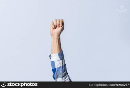 Hand gesturing the letter M in sign language on an isolated background. Man&rsquo;s hand gesturing the letter M of the alphabet isolated. Letter M of the alphabet in sign language
