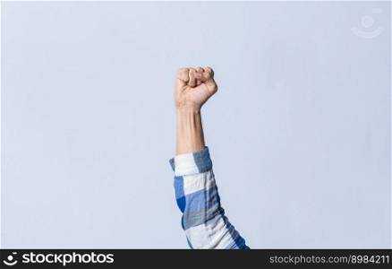 Hand gesturing the letter S in sign language on an isolated background. Man&rsquo;s hand gesturing the letter S of the alphabet isolated. Letter S of the alphabet in sign language