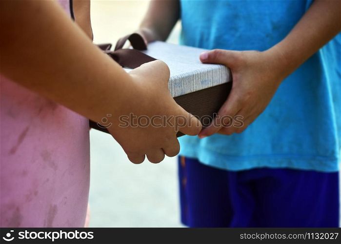 Hand giving gift box,Underprivileged children in Southeast Asia