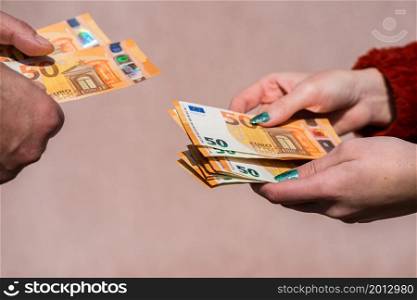 Hand giving money like bribe or tips or salary isolated, hard worked hand taking euro banknotes. Currency transfer and reward for hard work.. Hand giving money like bribe or tips or salary isolated, hard worked hand taking euro banknotes. Currency transfer and reward for hard work.
