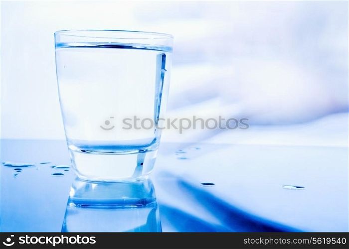 Hand grabbing a glass of water