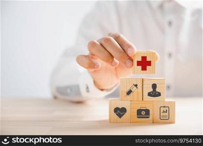 Hand grasps wooden block with healthcare and medical icons, symbolizing safety, health, and family well-being. Embodying pharmacy, heart care, and happiness concepts. health care concept