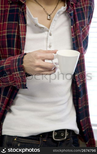 Hand having a coffee cup