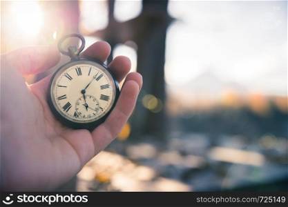 Hand held stop watch outdoors, autumn, blurry background