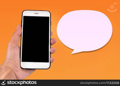 Hand hold mobile smart phone and Chat bubble on orange background