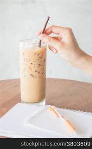 Hand hold straw of ice coffee, stock photo