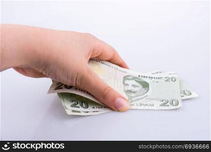 Hand holding 20 Turksh Lira banknote on white background