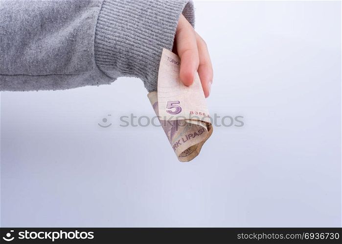 Hand holding 5 Turksh Lira banknote on white background