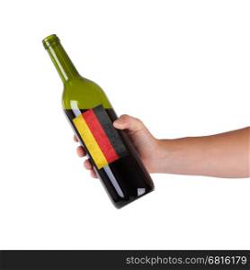 Hand holding a bottle of red wine, label of Germany, isolated on white,